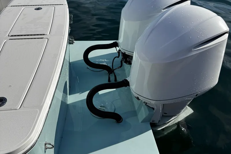 Slide: The Image of 2015 Regulator 28 Forward Seating boat with dual outboard engines on water. - 41