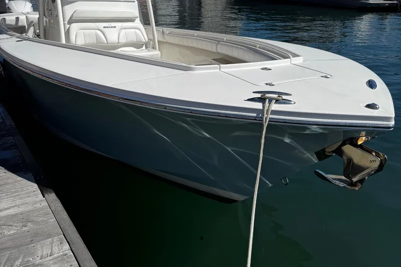 Slide: The Image of 2015 Regulator 28 Forward Seating boat docked in calm water. - 7