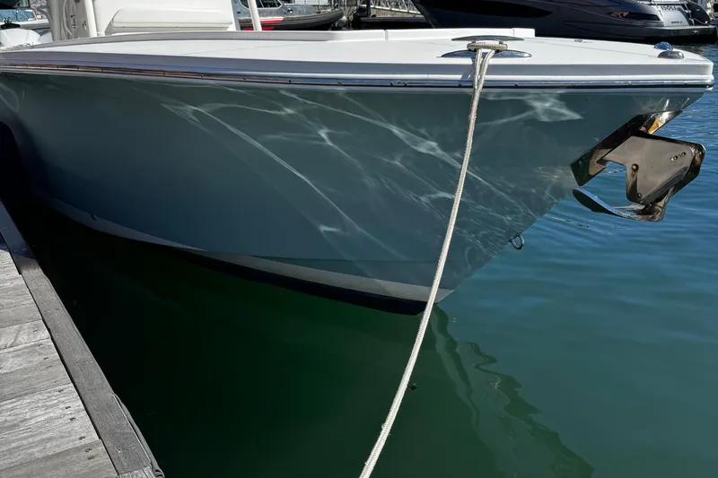 Slide: The Image of 2015 Regulator 28 Forward Seating boat docked, reflecting sunlight on water. - 8