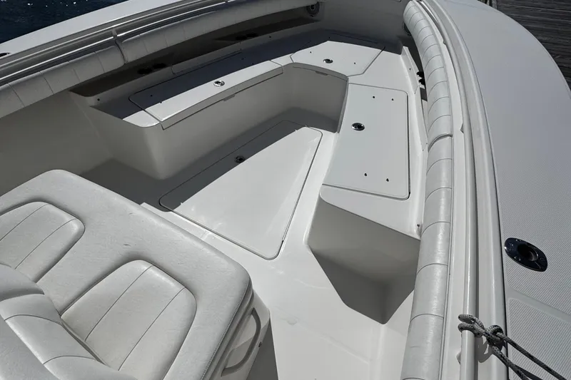 Slide: The Image of 2015 Regulator 28 Forward Seating boat interior with white cushioned seats and storage compartments. - 9