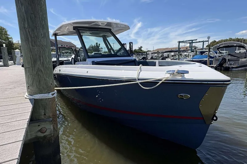 The Image of 2026 Monterey 25 Elite boat docked at marina under clear blue sky. - 1