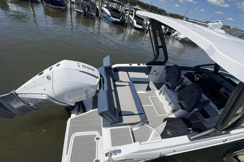 Slide: The Image of 2026 Monterey 25 Elite boat with sleek design, spacious seating, and powerful outboard motor. - 16