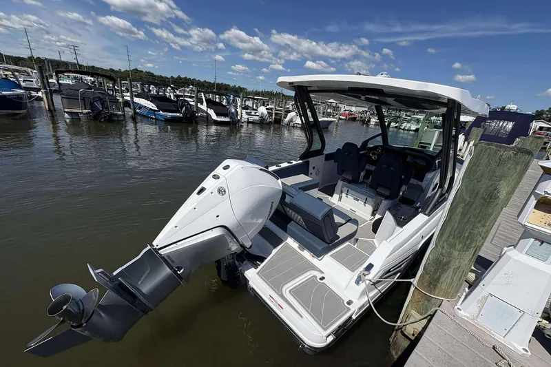 Slide: The Image of 2026 Monterey 25 Elite boat docked at marina under clear blue sky. - 17