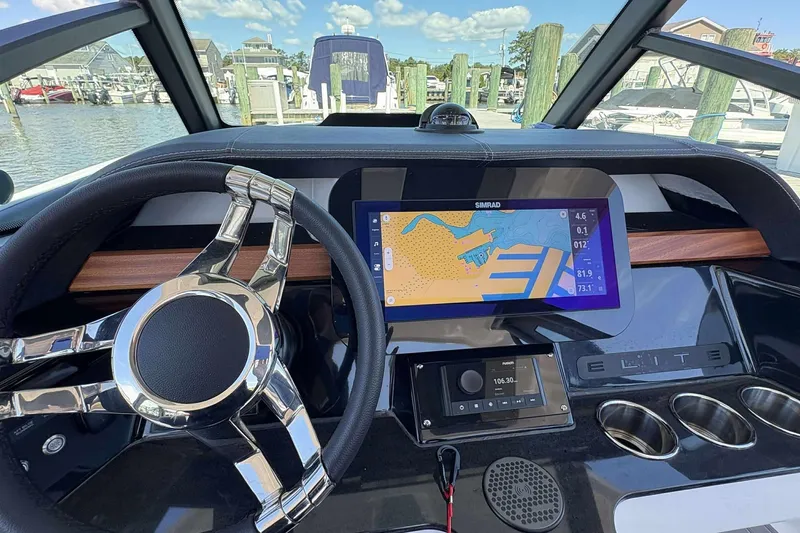Slide: The Image of Steering wheel and dashboard of 2026 Monterey 25 Elite boat with navigation display. - 18