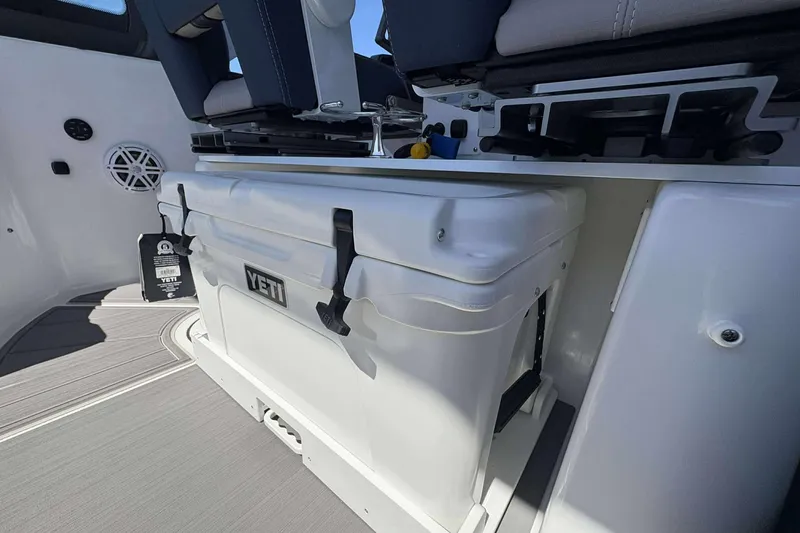 Slide: The Image of Interior of 2026 Monterey 25 Elite boat featuring a Yeti cooler and seating area. - 19