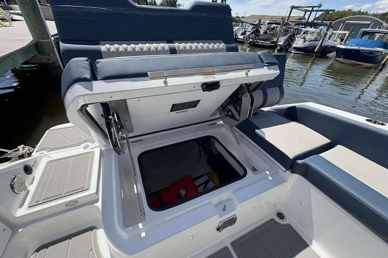 Slide: The Image of 2026 Monterey 25 Elite boat with open storage compartment at marina. - 20