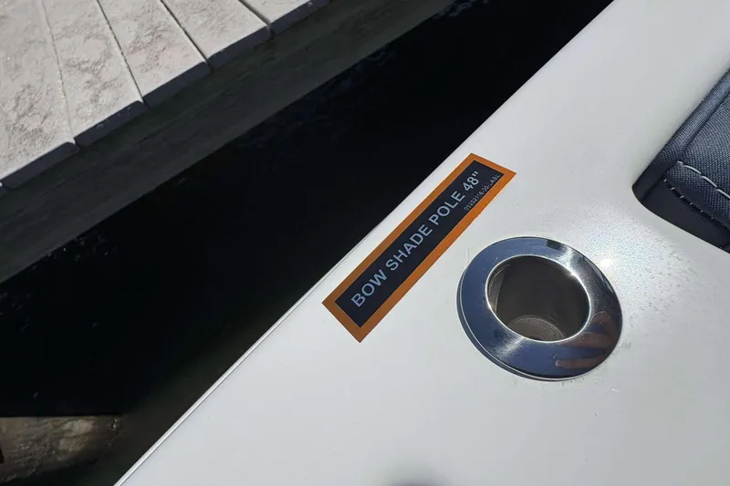 Slide: The Image of 2026 Monterey 25 Elite boat with bow shade pole holder near dock. - 24