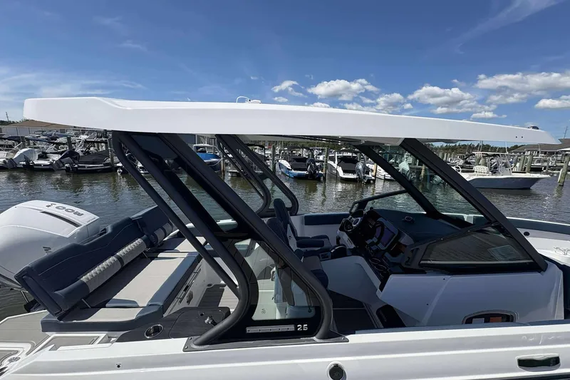 Slide: The Image of 2026 Monterey 25 Elite boat docked at marina under clear blue sky. - 3