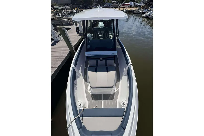 Slide: The Image of 2026 Monterey 25 Elite boat docked, showcasing sleek design and spacious seating. - 7