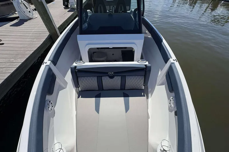 Slide: The Image of 2026 Monterey 25 Elite boat interior, featuring sleek seating and modern design at the dock. - 8