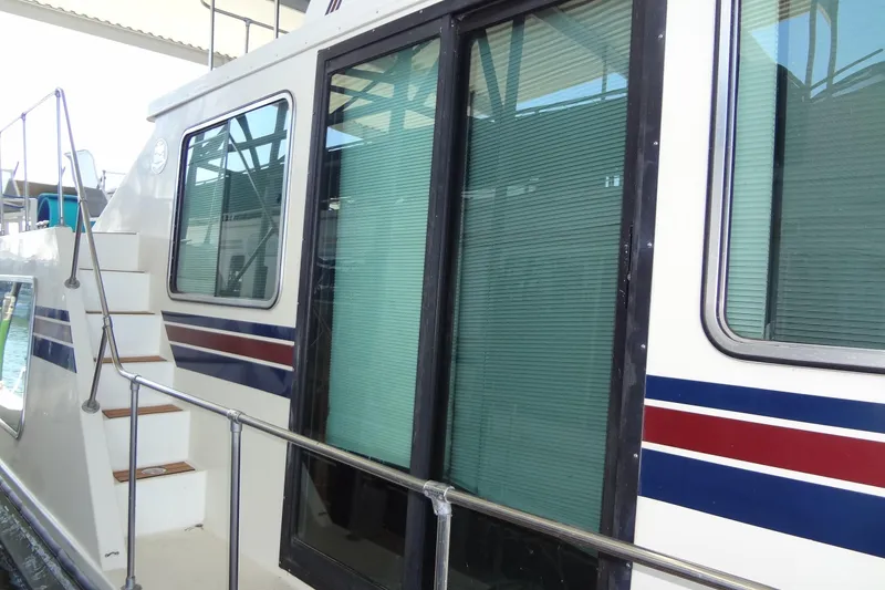Slide: The Image of 1995 Harbor Master 52 boat with sliding glass doors and exterior stairs. - 10