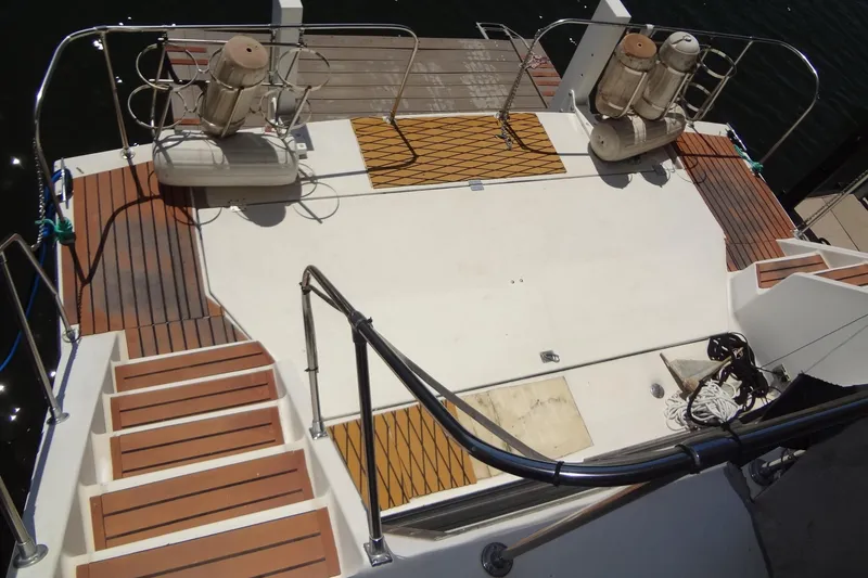 Slide: The Image of Deck view of a 1995 Harbor Master 52 yacht with wooden steps and railings. - 14