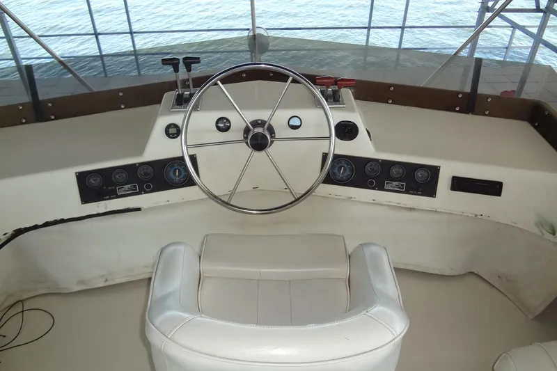 Slide: The Image of Helm of 1995 Harbor Master 52 boat with steering wheel and control panel. - 19