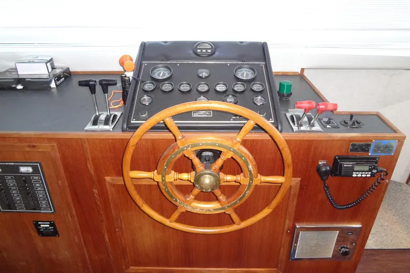 Slide: The Image of Control panel of a 1995 Harbor Master 52 boat with wooden steering wheel. - 24