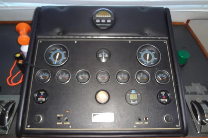 Slide: The Image of Control panel of a 1995 Harbor Master 52 boat with various gauges and switches. - 25