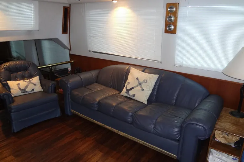 Slide: The Image of Luxurious 1995 Harbor Master 52 yacht interior with blue leather seating and nautical decor. - 29