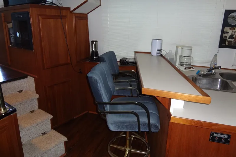 Slide: The Image of Interior of 1995 Harbor Master 52 with bar stools, kitchenette, and stairs. - 31