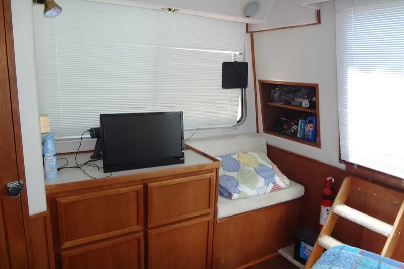 Slide: The Image of Interior of 1995 Harbor Master 52 boat with TV, seating, and storage shelves. - 37