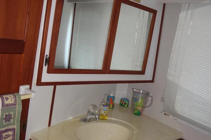Slide: The Image of Bathroom vanity with mirror in 1995 Harbor Master 52 boat. - 39