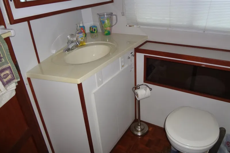 Slide: The Image of Bathroom interior of a 1995 Harbor Master 52 boat with sink and toilet. - 40