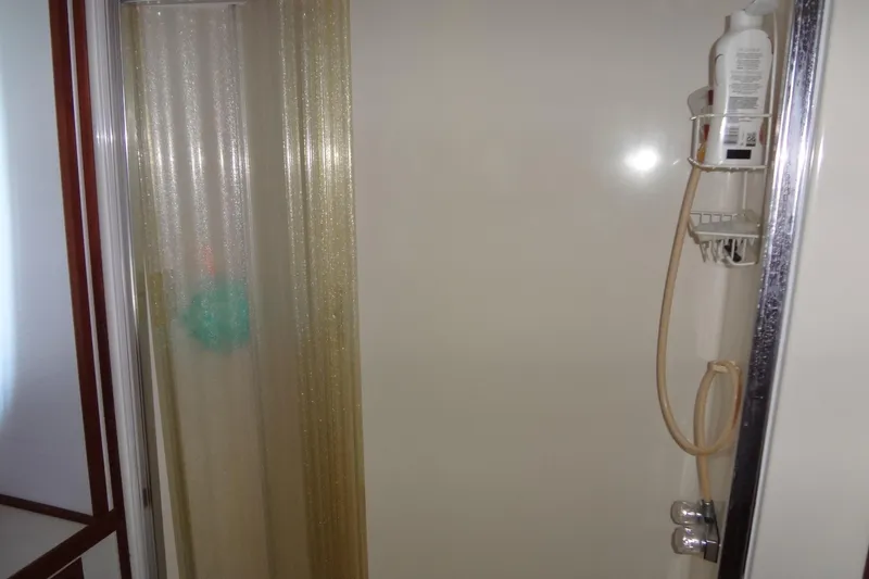Slide: The Image of Shower area in 1995 Harbor Master 52 boat with curtain and toiletries. - 41