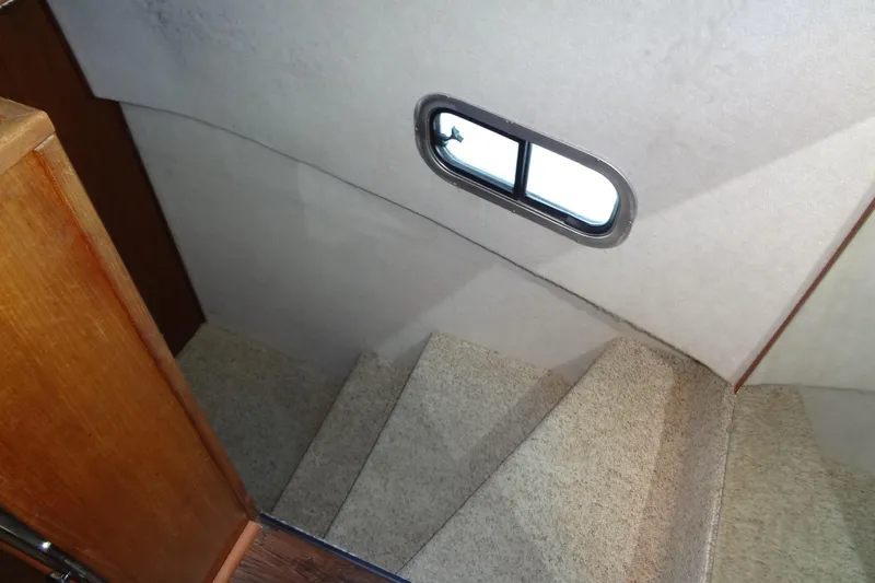 Slide: The Image of Staircase inside 1995 Harbor Master 52 boat with small window. - 42