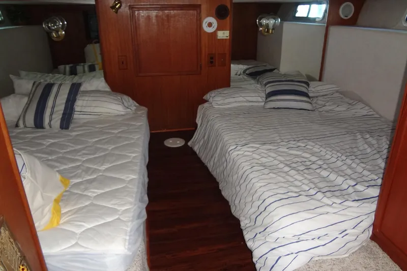 Slide: The Image of Interior of 1995 Harbor Master 52 with two cozy beds and striped bedding. - 43