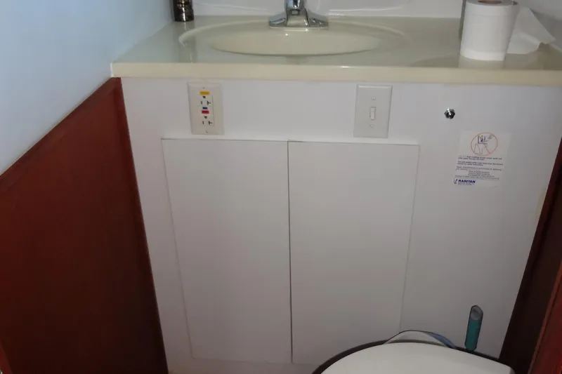 Slide: The Image of Bathroom sink and cabinet in a 1995 Harbor Master 52 boat. - 44