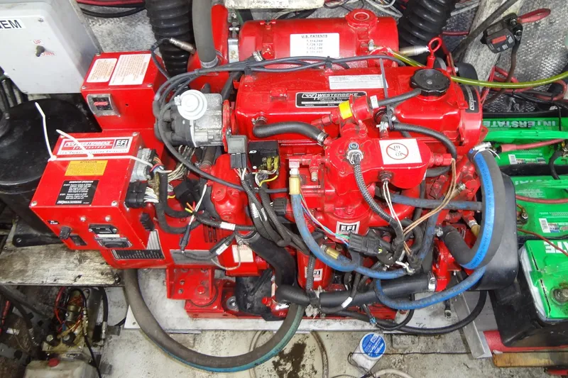Slide: The Image of Red engine of a 1995 Harbor Master 52 boat, featuring complex wiring and components. - 45