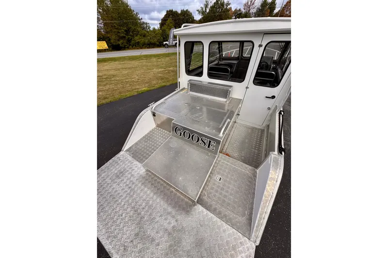 Slide: The Image of 2018 Stanley 27 Custom boat with "Goose" label, featuring aluminum deck and cabin. - 1