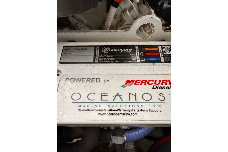 Slide: The Image of Engine compartment of a 2018 Stanley 27 Custom, featuring Mercury Diesel and Oceanos Marine branding. - 16