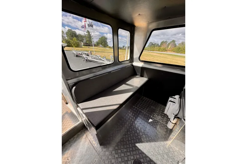 Slide: The Image of Interior of a 2018 Stanley 27 Custom boat with bench seating and large windows. - 4