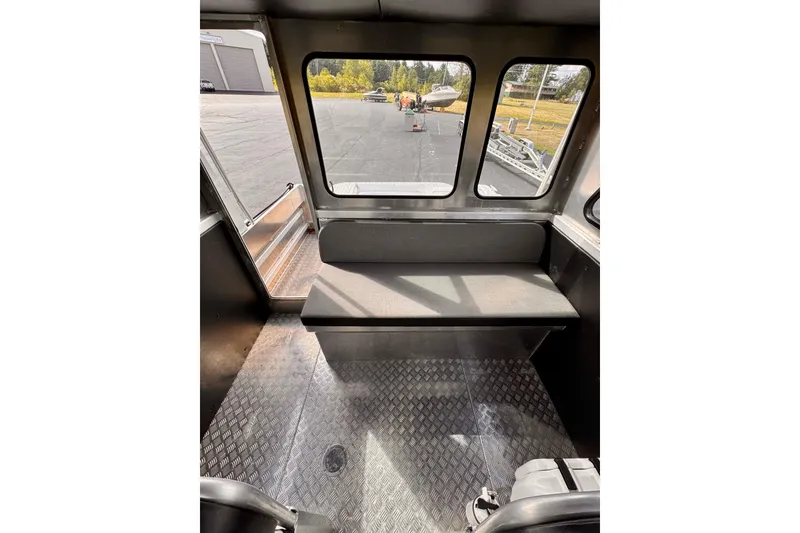 Slide: The Image of Interior of a 2018 Stanley 27 Custom boat with bench seating and diamond plate flooring. - 5