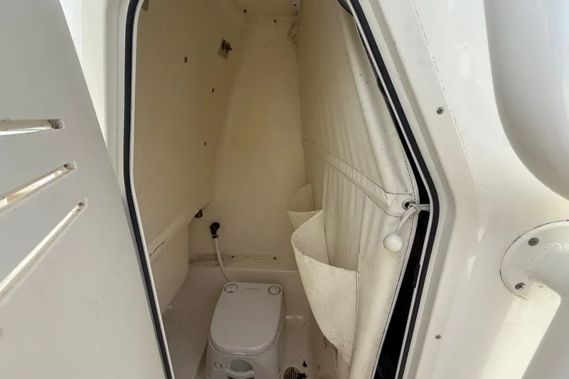 Slide: The Image of 2018 Key West 219 FS boat interior with compact marine toilet. - 18