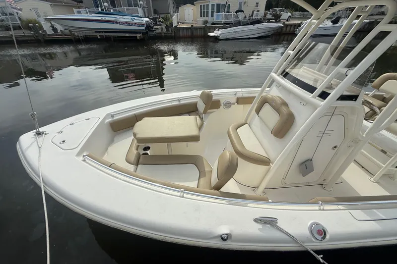 Slide: The Image of 2018 Key West 219 FS boat with beige seating, docked in a marina. - 25