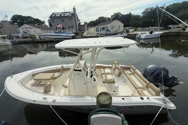 Slide: The Image of 2018 Key West 219 FS boat docked in a serene marina setting. - 3