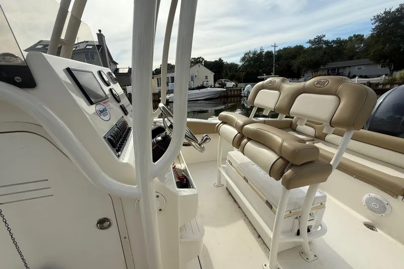 Slide: The Image of 2018 Key West 219 FS boat interior with beige seating and control panel. - 34