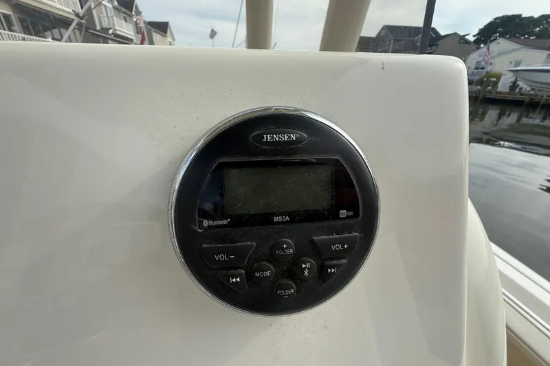 Slide: The Image of 2018 Key West 219 FS boat with Jensen audio system, docked near waterfront homes. - 36