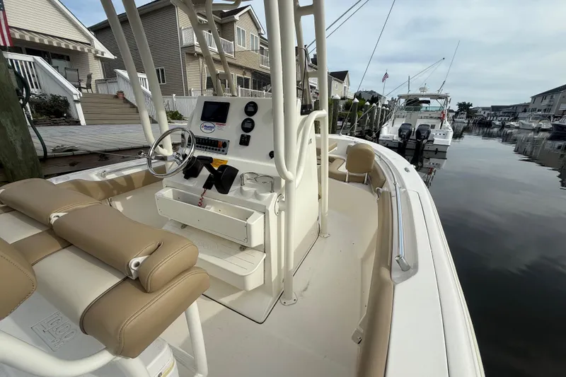 Slide: The Image of 2018 Key West 219 FS boat docked in a residential marina setting. - 5