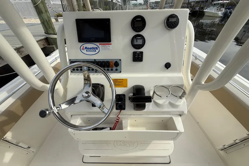 Slide: The Image of 2018 Key West 219 FS boat console with steering wheel and control panel. - 6