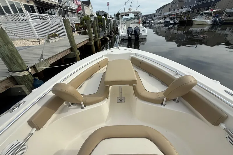 Slide: The Image of 2018 Key West 219 FS boat with tan seating, docked in a marina. - 9