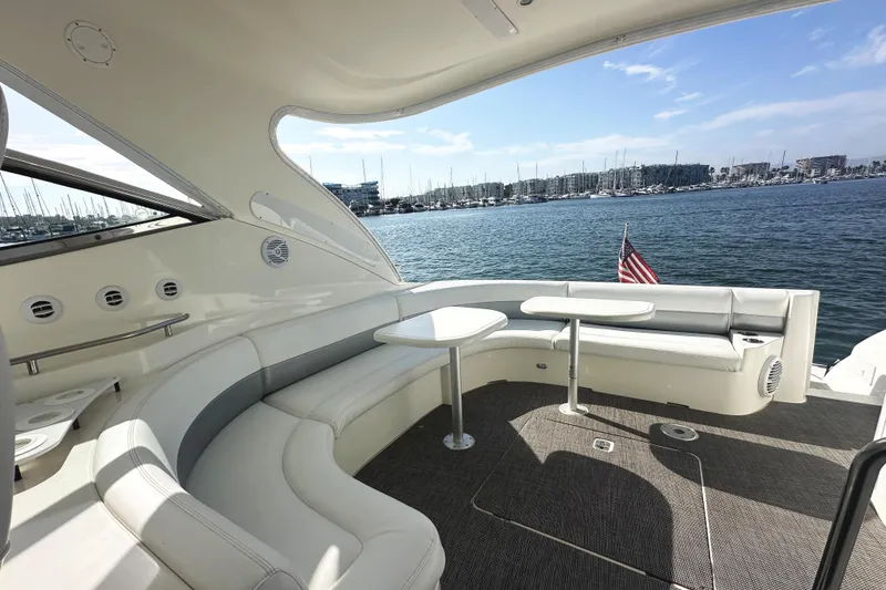 Slide: The Image of 2007 Cruisers Yachts 540 Express, luxurious deck view with seating, overlooking marina. - 15