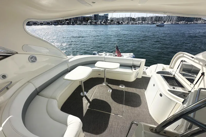 Slide: The Image of Luxurious 2007 Cruisers Yachts 540 Express deck with seating, tables, and waterfront view. - 16
