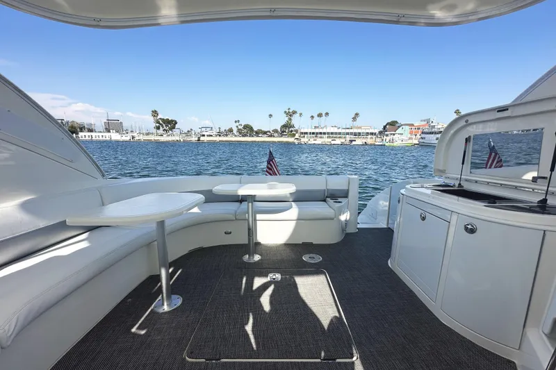 Slide: The Image of 2007 Cruisers Yachts 540 Express interior with seating, tables, and waterfront view. - 18