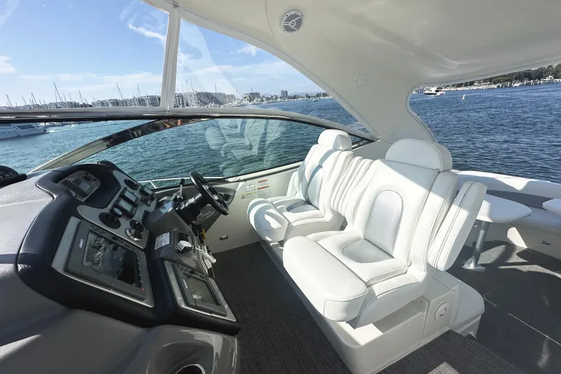 Slide: The Image of 2007 Cruisers Yachts 540 Express cockpit with luxurious seating and modern controls, overlooking marina. - 22