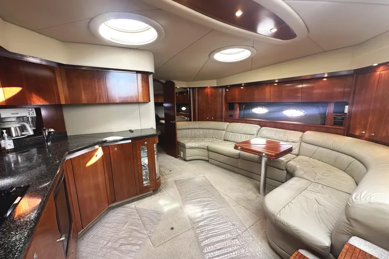 Slide: The Image of Luxurious interior of 2007 Cruisers Yachts 540 Express with leather seating and wooden cabinetry. - 25