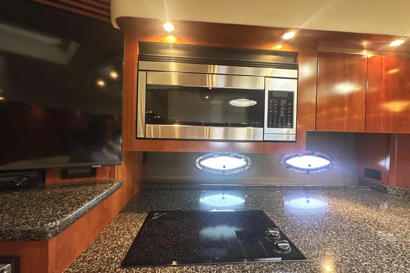Slide: The Image of Luxurious 2007 Cruisers Yachts 540 Express kitchen with modern appliances and sleek design. - 28