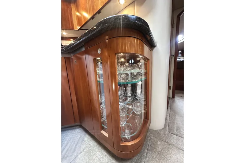Slide: The Image of Luxurious wooden cabinet with glassware in 2007 Cruisers Yachts 540 Express. - 30