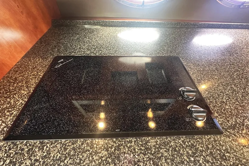 Slide: The Image of Granite countertop with electric cooktop on 2007 Cruisers Yachts 540 Express. - 31