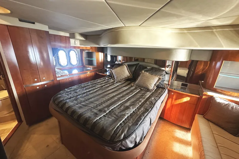 Slide: The Image of Luxurious 2007 Cruisers Yachts 540 Express bedroom with elegant wood finishes and plush bedding. - 35